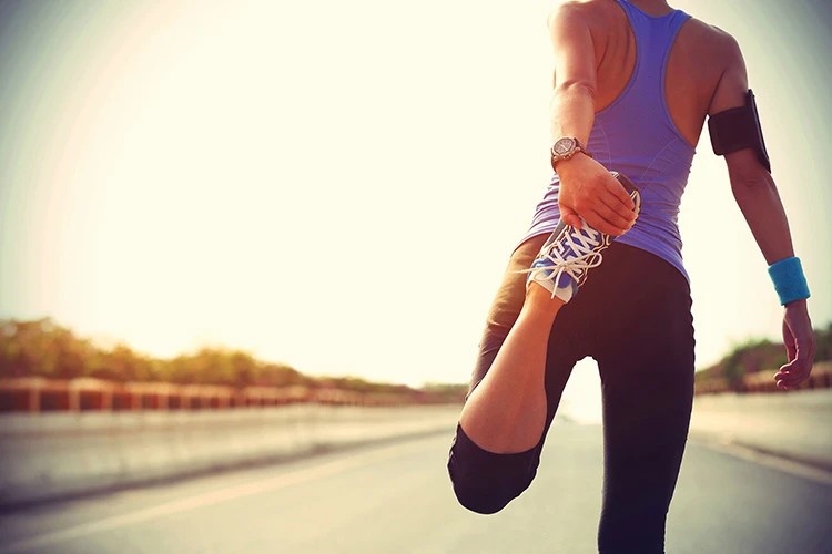 woman stretching before running